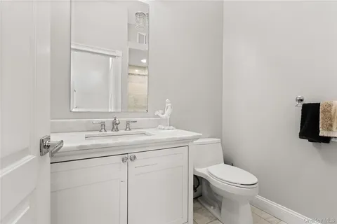 a bedroom with a bed lamp and a large window