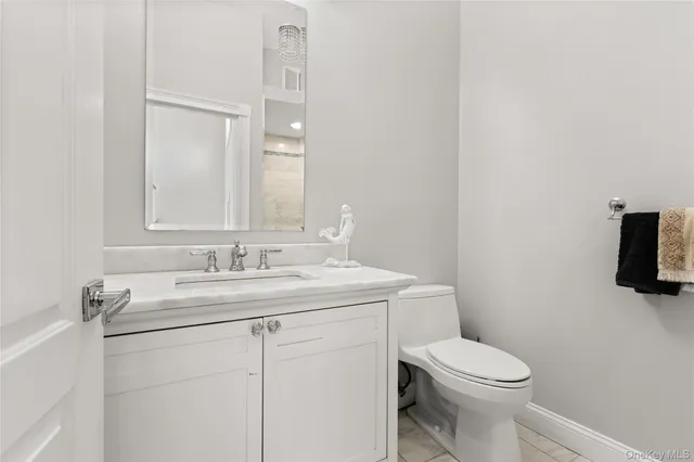 a bedroom with a bed lamp and a large window