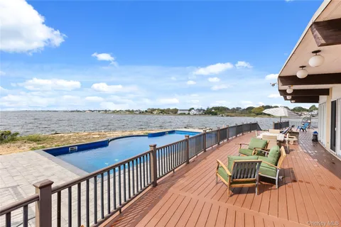 an empty room with a fireplace and stainless steel appliances