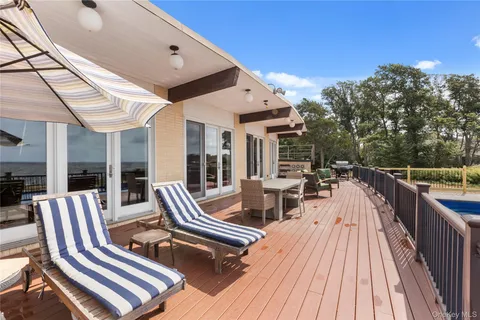 a view of a balcony with wooden floor and city view