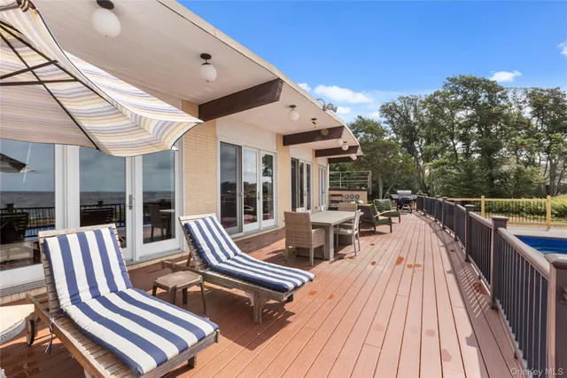 a view of a balcony with wooden floor and city view