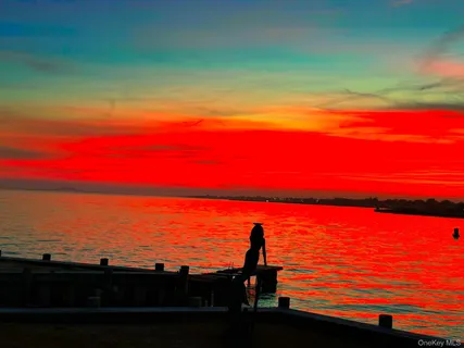 a picture of a bathroom with a white wall and a picture of a painting
