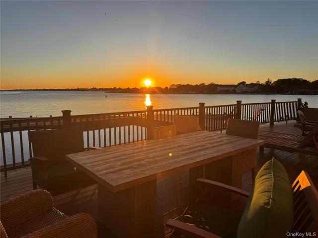 a view of a balcony with wooden floor and city view