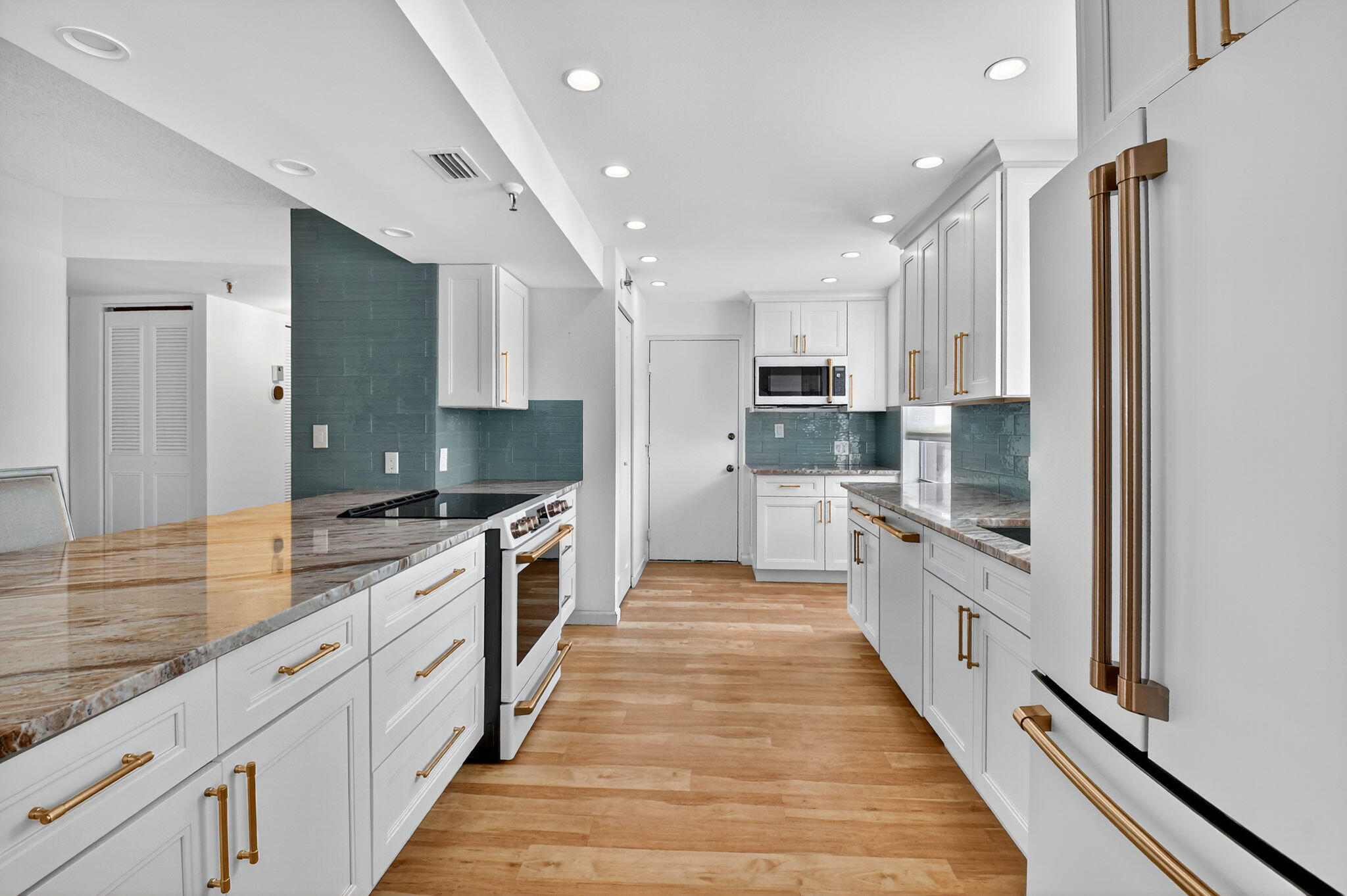 5340 Northwest 2nd Avenue, Unit 220 Boca Raton, FL 33487 - Photo 13 of 46 a large kitchen with stainless steel appliances double vanity sink and a large window