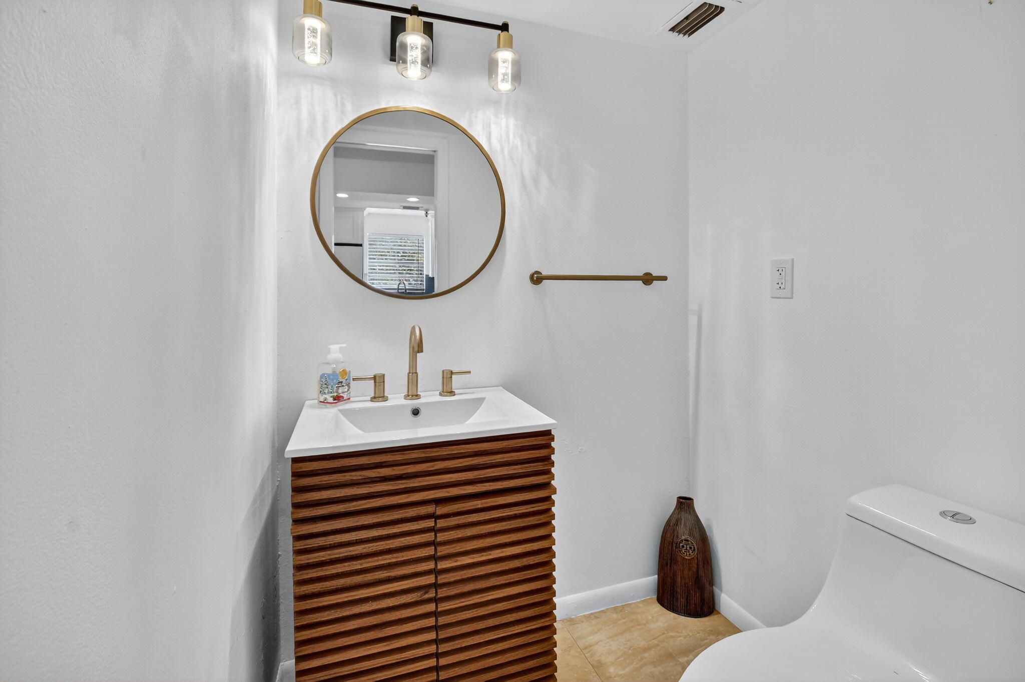5340 Northwest 2nd Avenue, Unit 220 Boca Raton, FL 33487 - Photo 17 of 46 a bathroom with a sink mirror vanity and toilet