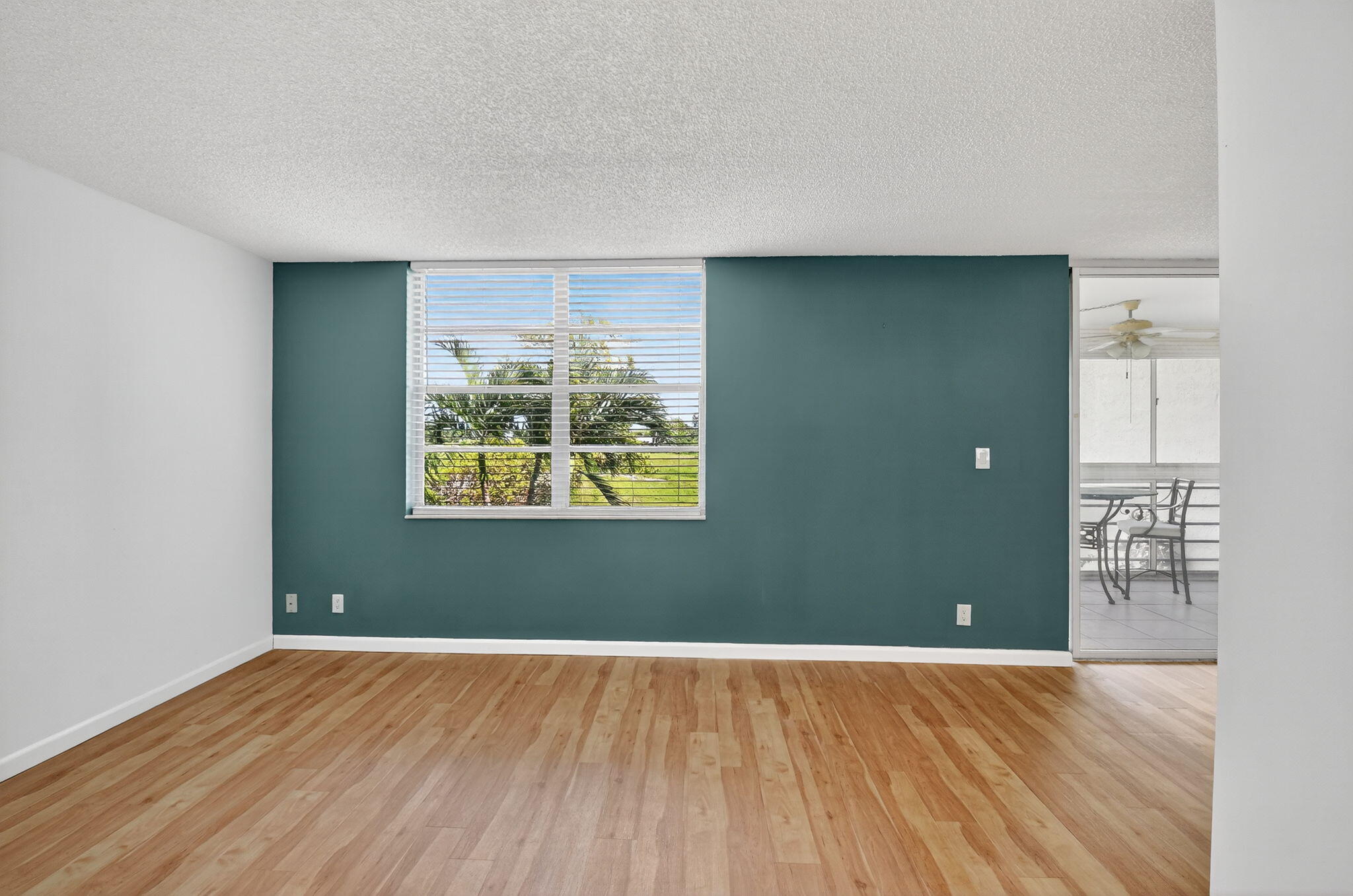 5340 Northwest 2nd Avenue, Unit 220 Boca Raton, FL 33487 - Photo 20 of 46 an empty room with wooden floor and windows