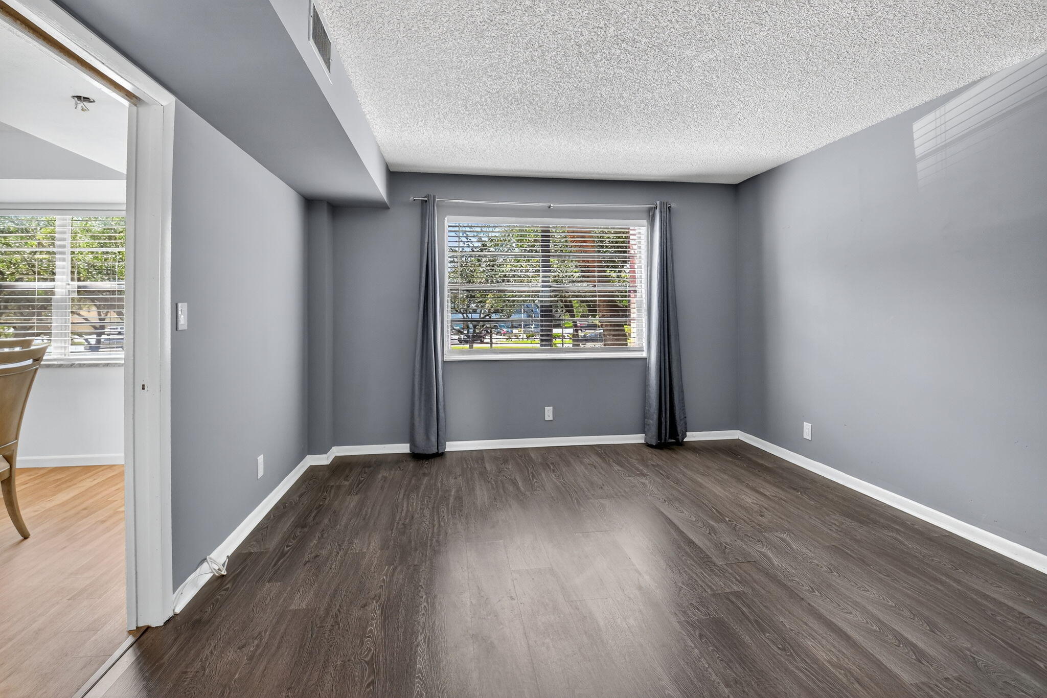 5340 Northwest 2nd Avenue, Unit 220 Boca Raton, FL 33487 - Photo 25 of 46 an empty room with wooden floor and windows