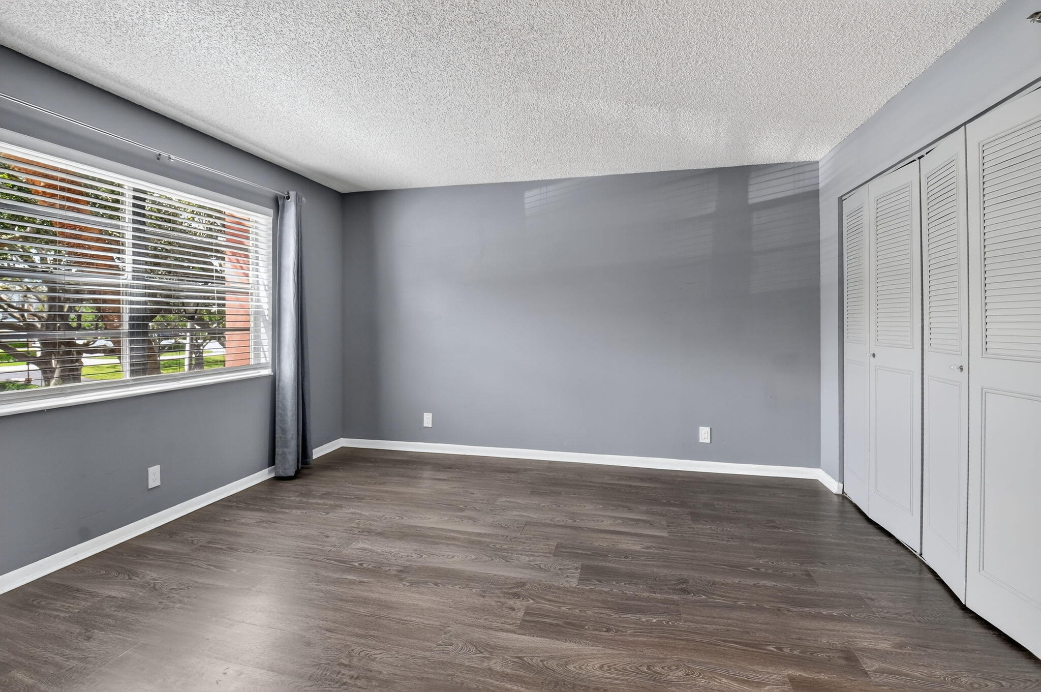 5340 Northwest 2nd Avenue, Unit 220 Boca Raton, FL 33487 - Photo 27 of 46 a view of an empty room with wooden floor and a window