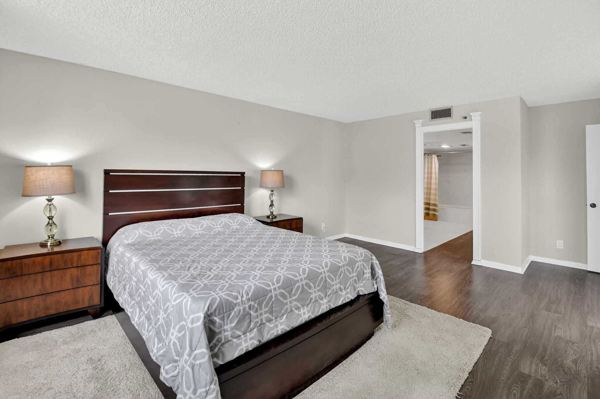 5340 Northwest 2nd Avenue, Unit 220 Boca Raton, FL 33487 - Photo 33 of 46 a bedroom with a bed and wooden floor