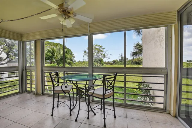 a view of a porch with chairs and backyard