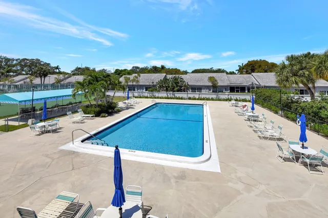 a swimming pool with outdoor seating and city view