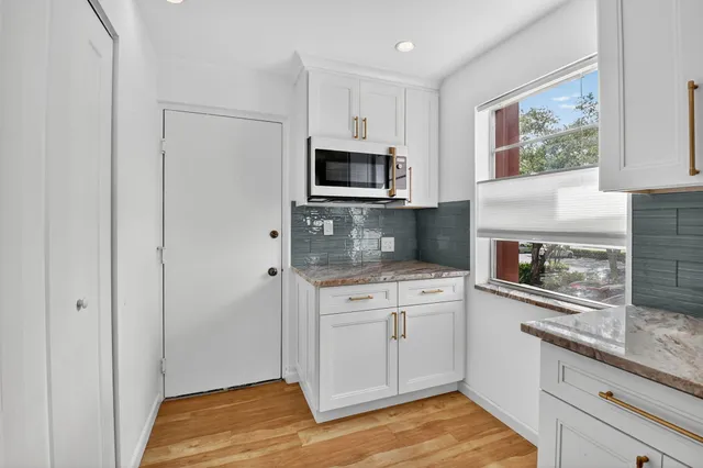 a kitchen with stainless steel appliances granite countertop a stove microwave and refrigerator