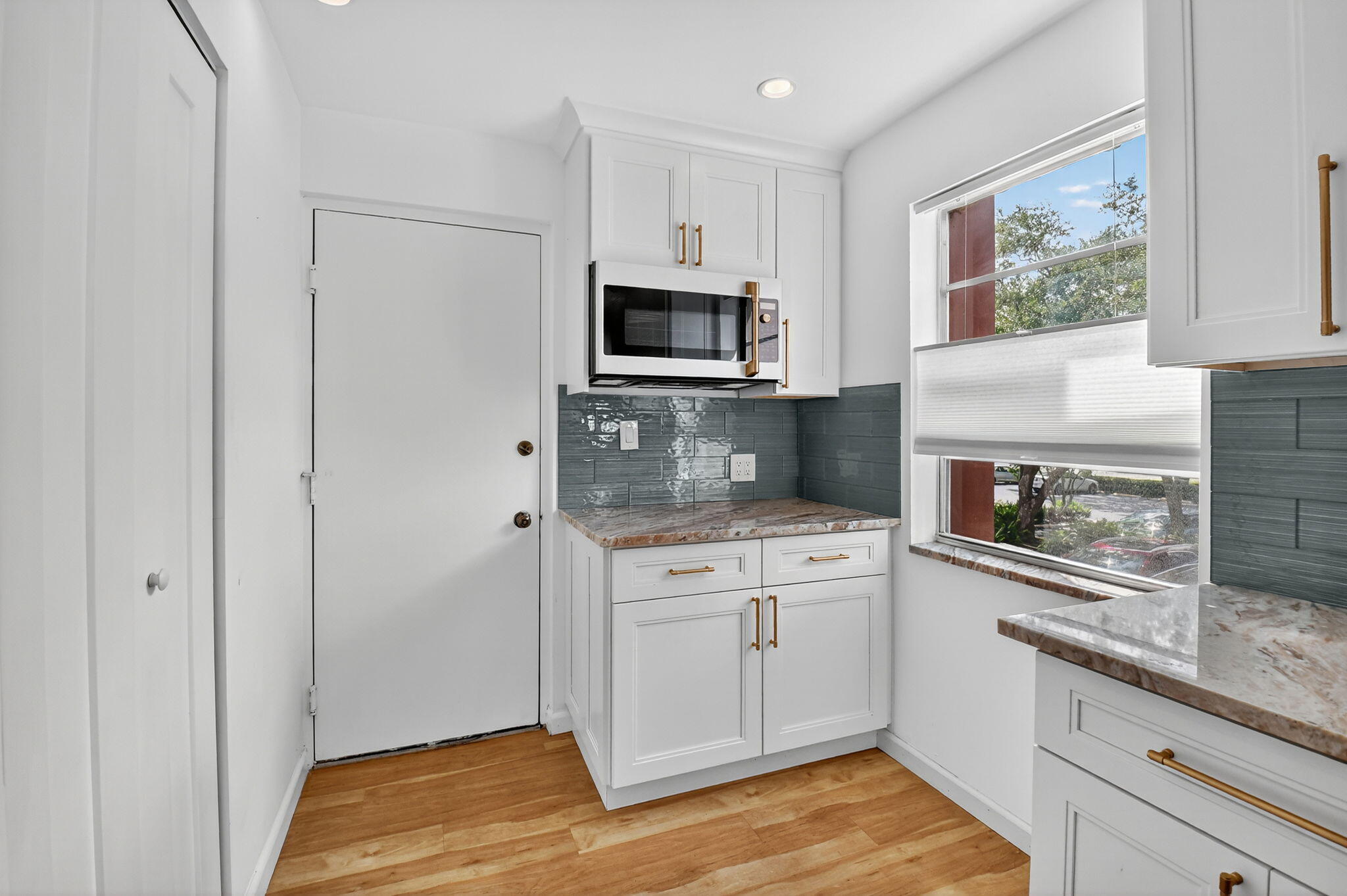 5340 Northwest 2nd Avenue, Unit 220 Boca Raton, FL 33487 - Photo 8 of 46 a kitchen with stainless steel appliances granite countertop a stove microwave and refrigerator