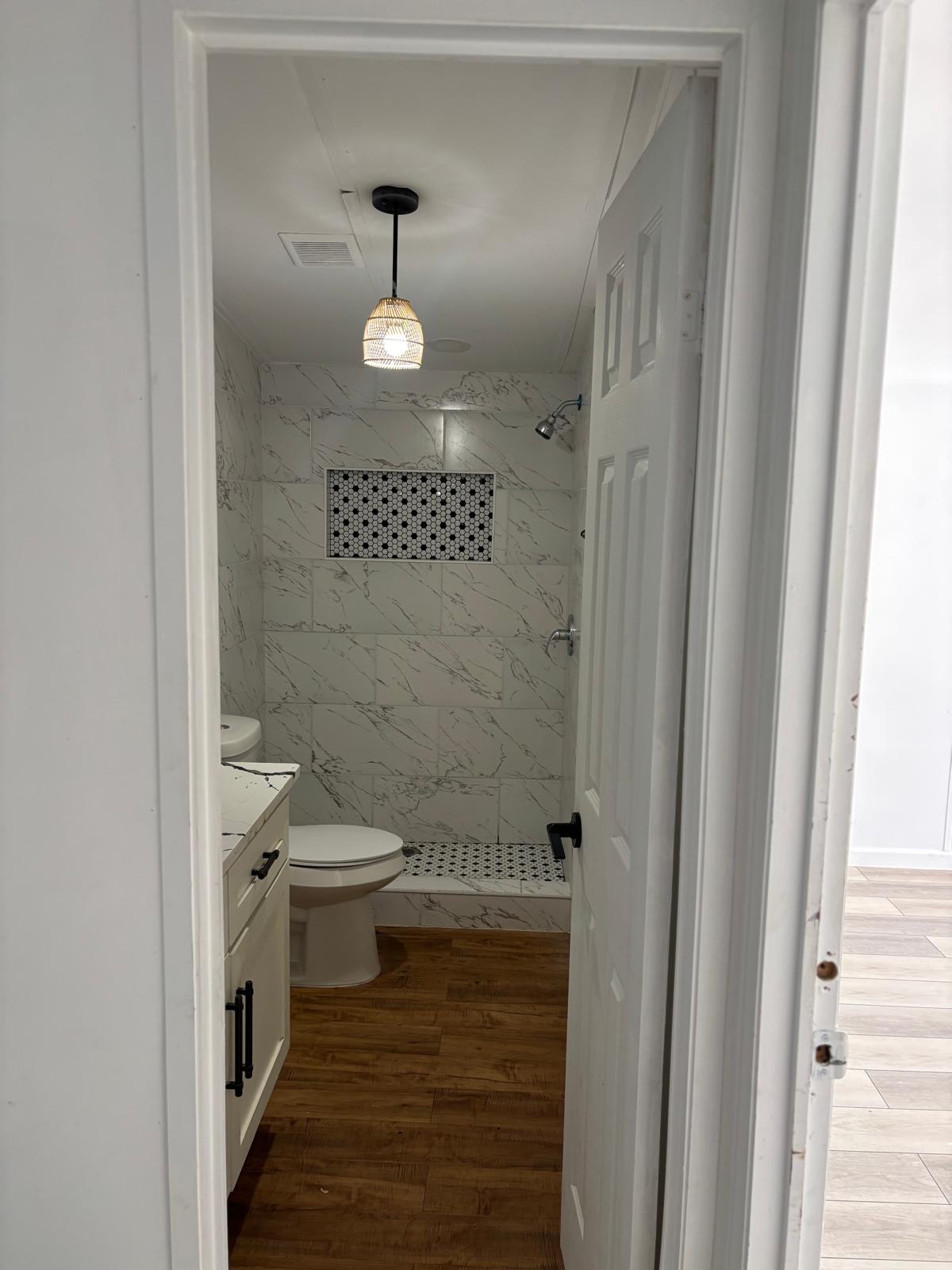 1109 Hurst Creek Road Austin, TX 78734 - Photo 12 of 18 Full bathroom with dark wood finished floors, vanity, and a marble finish shower