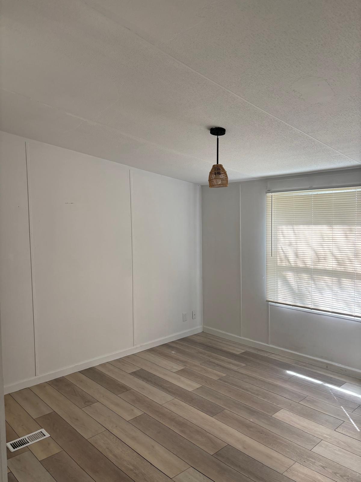 1109 Hurst Creek Road Austin, TX 78734 - Photo 17 of 18 Unfurnished room with light wood finished floors and a decorative wall