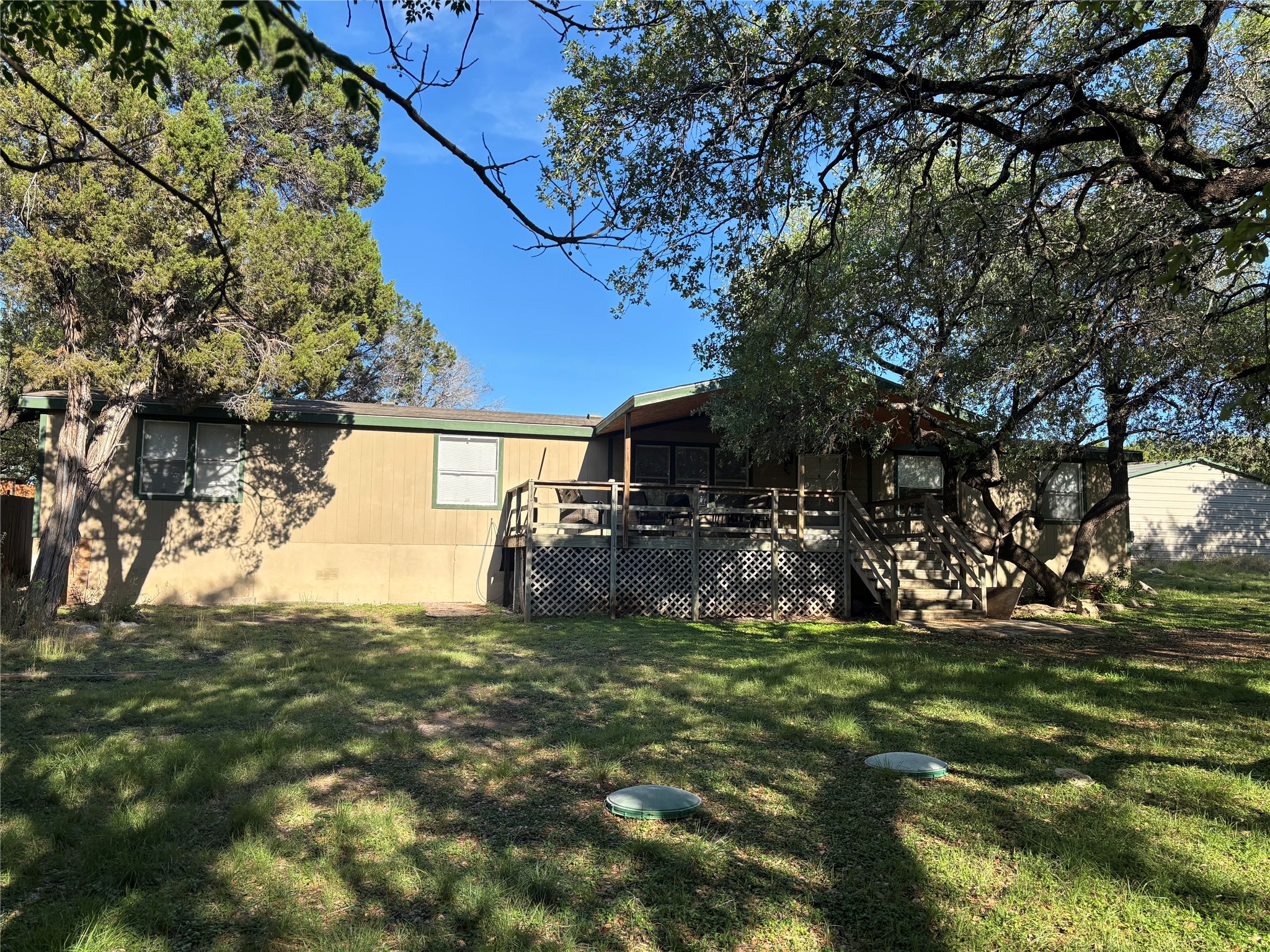 1109 Hurst Creek Road Austin, TX 78734 - Photo 2 of 18 Back of house featuring a deck, a yard, and a sunroom