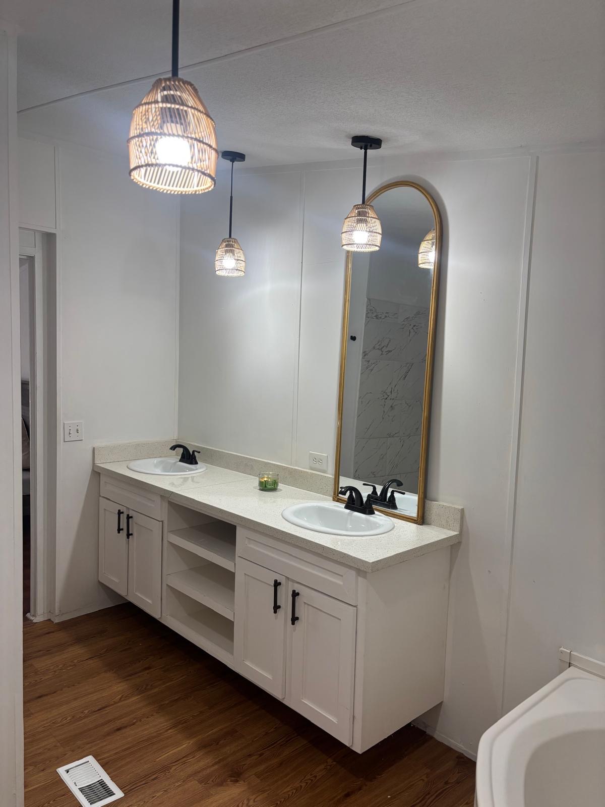 1109 Hurst Creek Road Austin, TX 78734 - Photo 7 of 18 Bathroom featuring double vanity, a decorative wall, and dark wood-type flooring