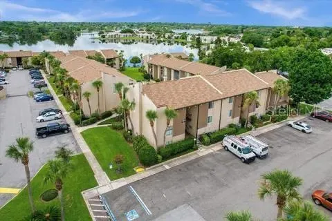 an aerial view of multiple houses with a yard