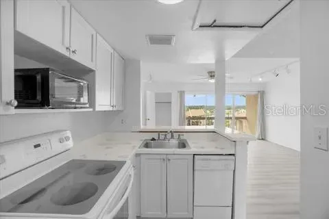 a kitchen with a sink cabinets and window