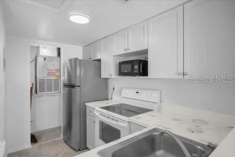 a kitchen with a sink a washer and stainless steel appliances