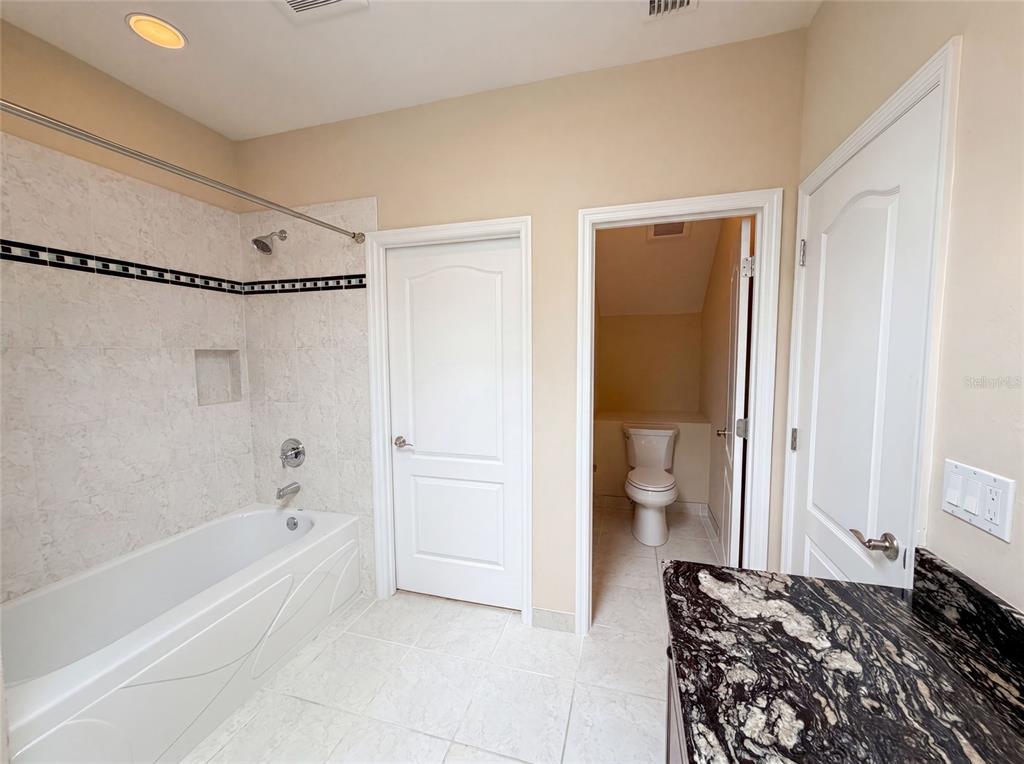13478 Northwest 9 Road Newberry, FL 32669 - Photo 23 of 31 a bathroom with a bathtub and a toilet