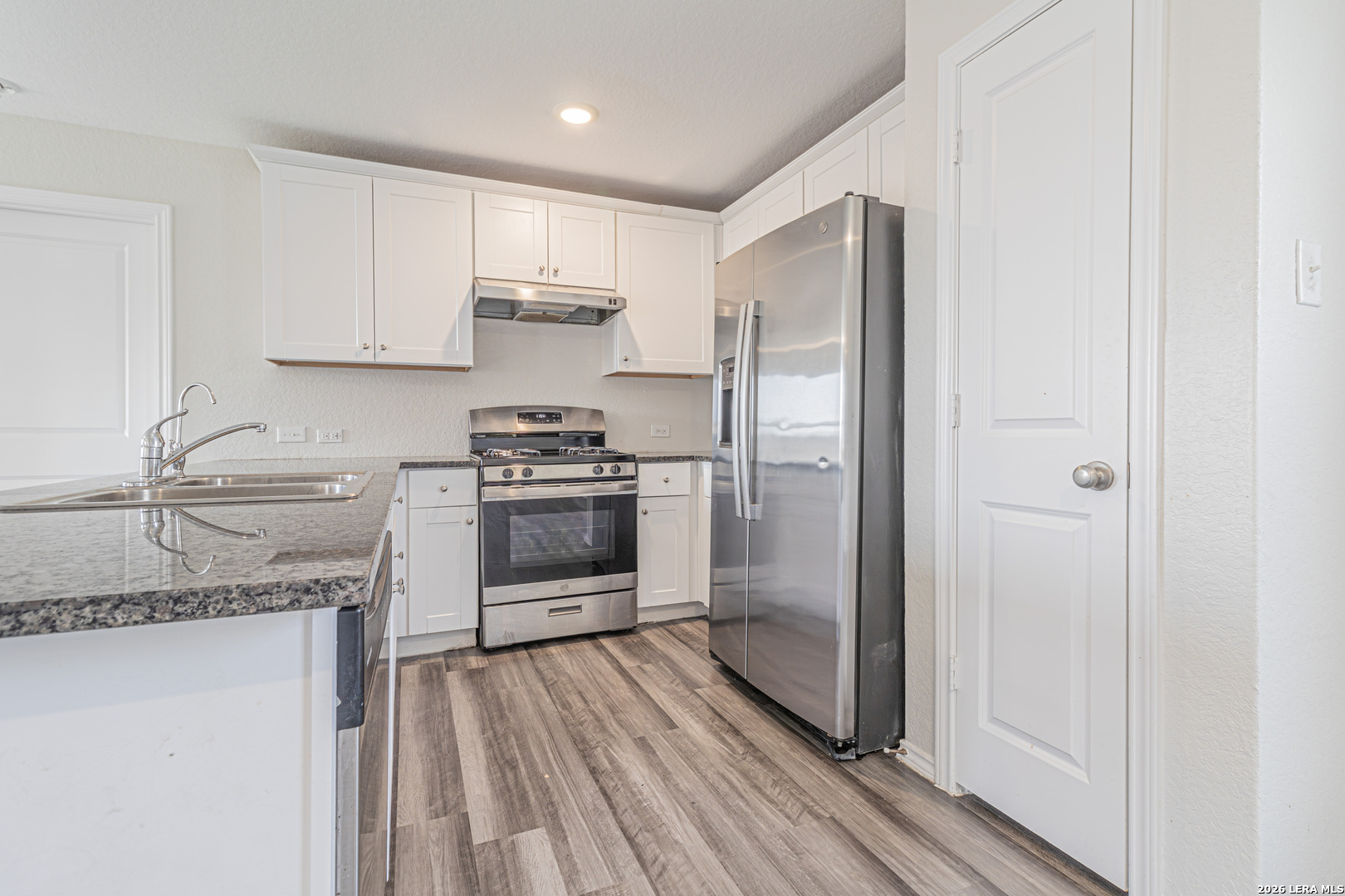 3814 Pickles Way Converse, TX 78109 - Photo 13 of 27 a kitchen with stainless steel appliances granite countertop a refrigerator a sink and white cabinets