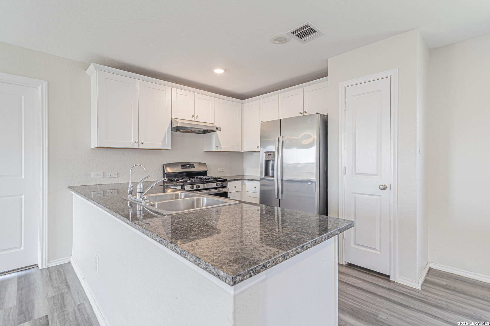 3814 Pickles Way Converse, TX 78109 - Photo 15 of 27 a kitchen with kitchen island a counter top space cabinets and stainless steel appliances