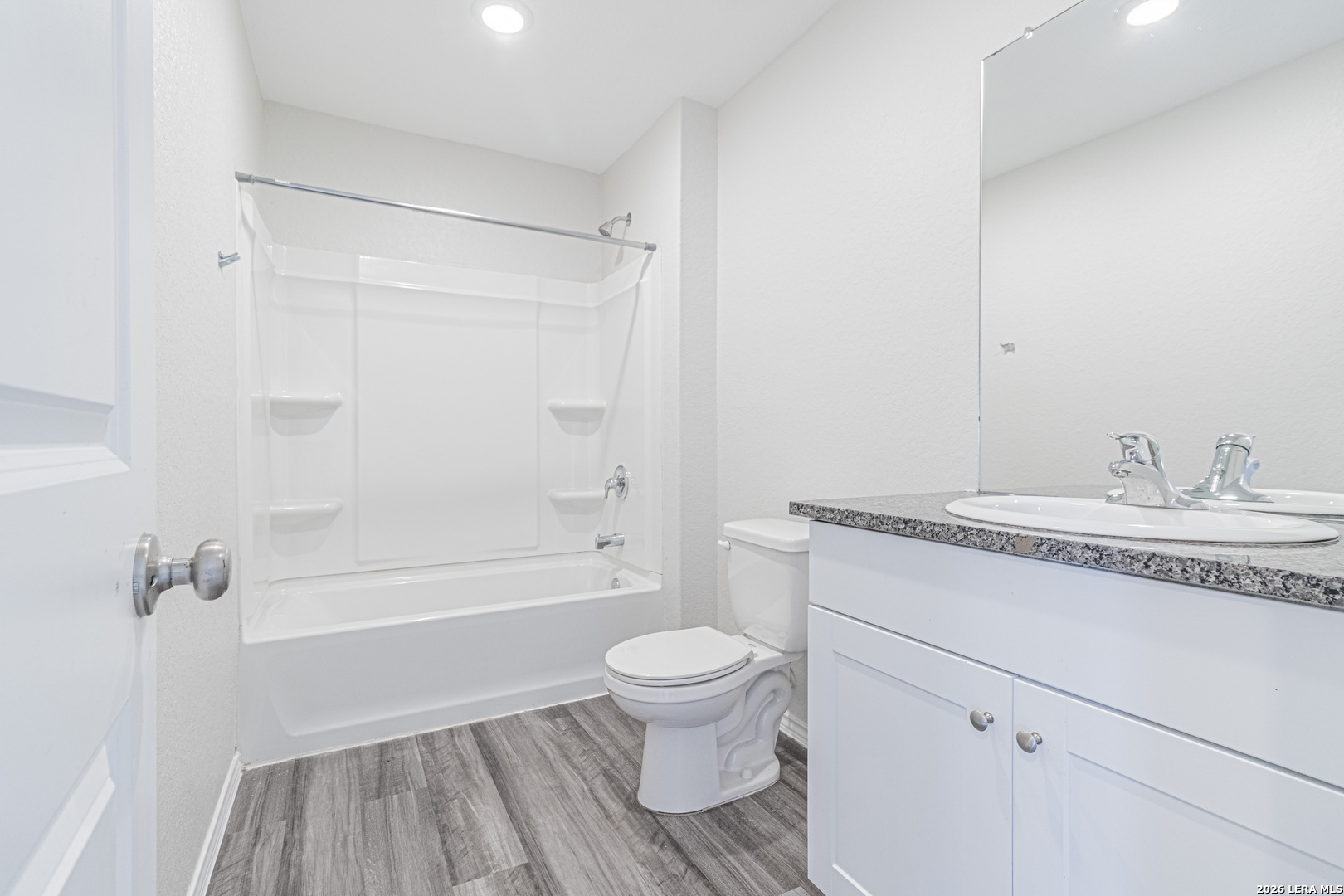 3814 Pickles Way Converse, TX 78109 - Photo 20 of 27 a bathroom with a granite countertop sink a toilet and shower