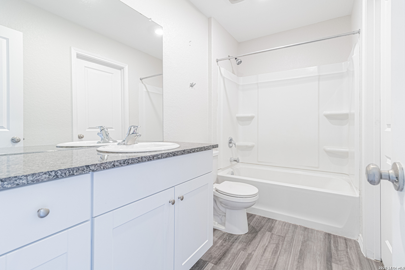 3814 Pickles Way Converse, TX 78109 - Photo 24 of 27 a bathroom with a granite countertop sink toilet a mirror and shower