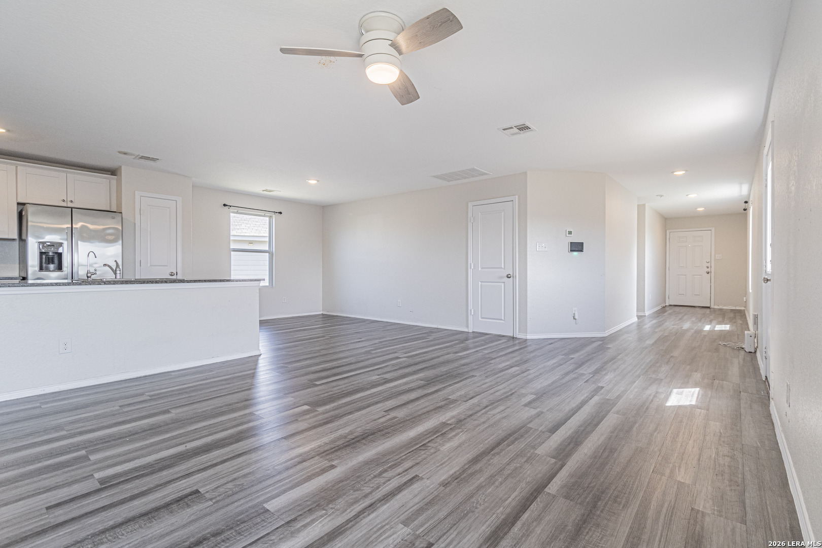 3814 Pickles Way Converse, TX 78109 - Photo 6 of 27 a view of a kitchen with wooden floor and a ceiling fan