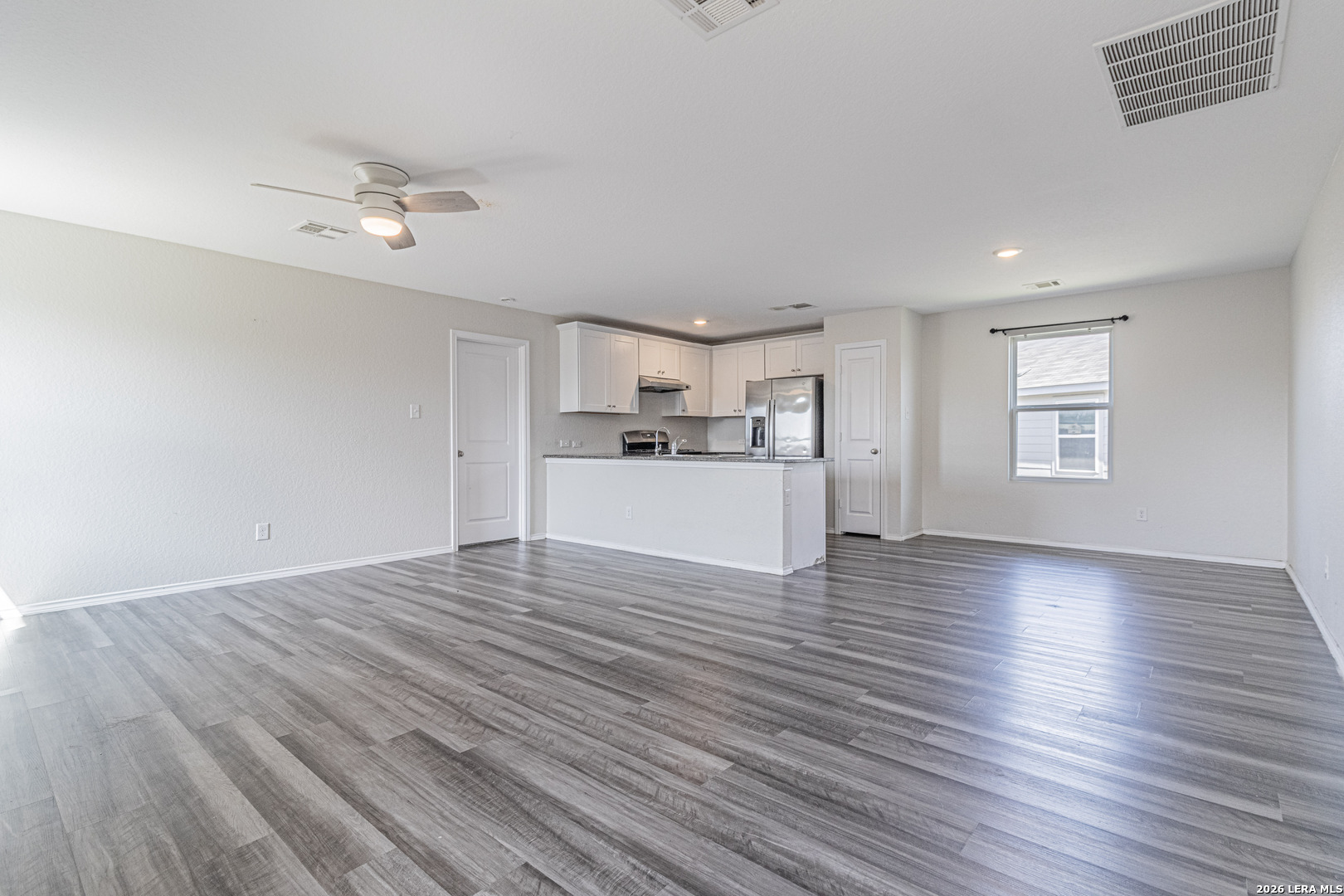 3814 Pickles Way Converse, TX 78109 - Photo 7 of 27 a view of a kitchen with a dishwasher cabinets and wooden floor