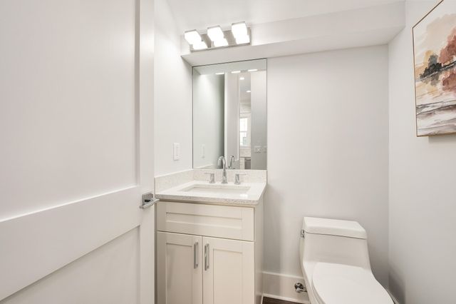a bathroom with a sink a toilet and a mirror