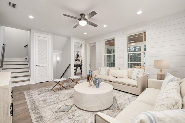 a living room with furniture and wooden floor