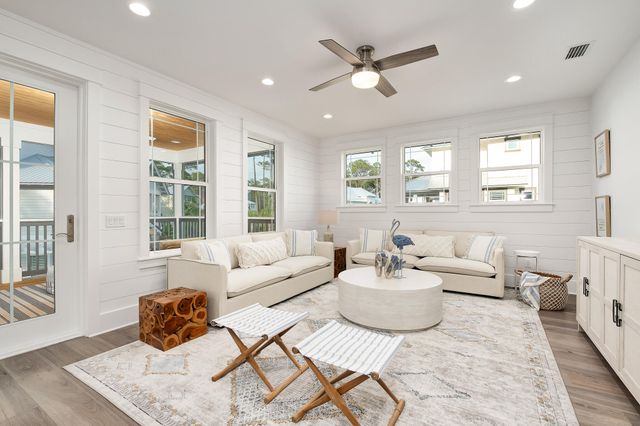 a living room with furniture and a large window