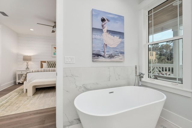 a white bath tub sitting next to a window