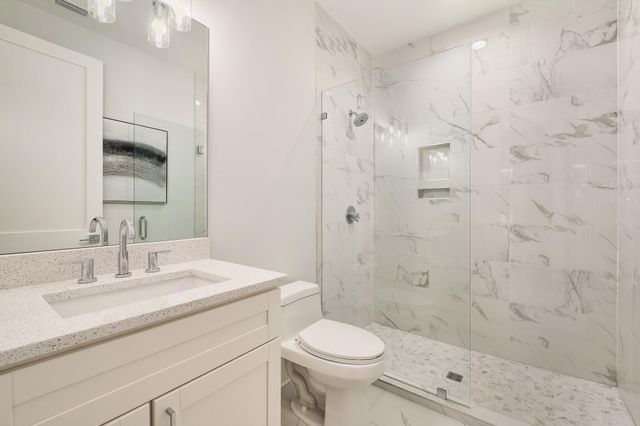 a bathroom with a sink toilet and shower