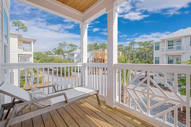 a view of a two chairs and table on the deck
