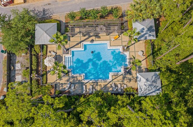 an aerial view of a house with a yard and lake view