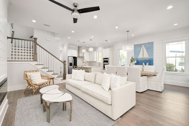 a living room with fireplace furniture and a wooden floor