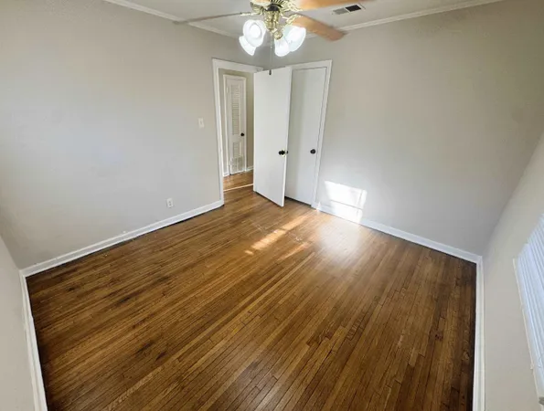 a view of a room with wooden floor and chandelier