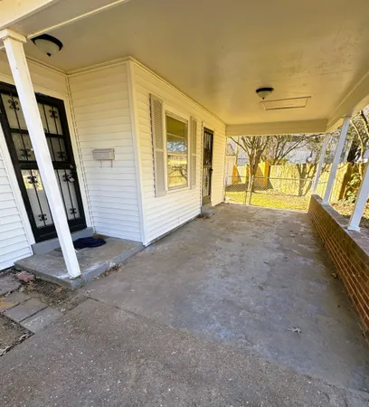a view of an empty room with windows