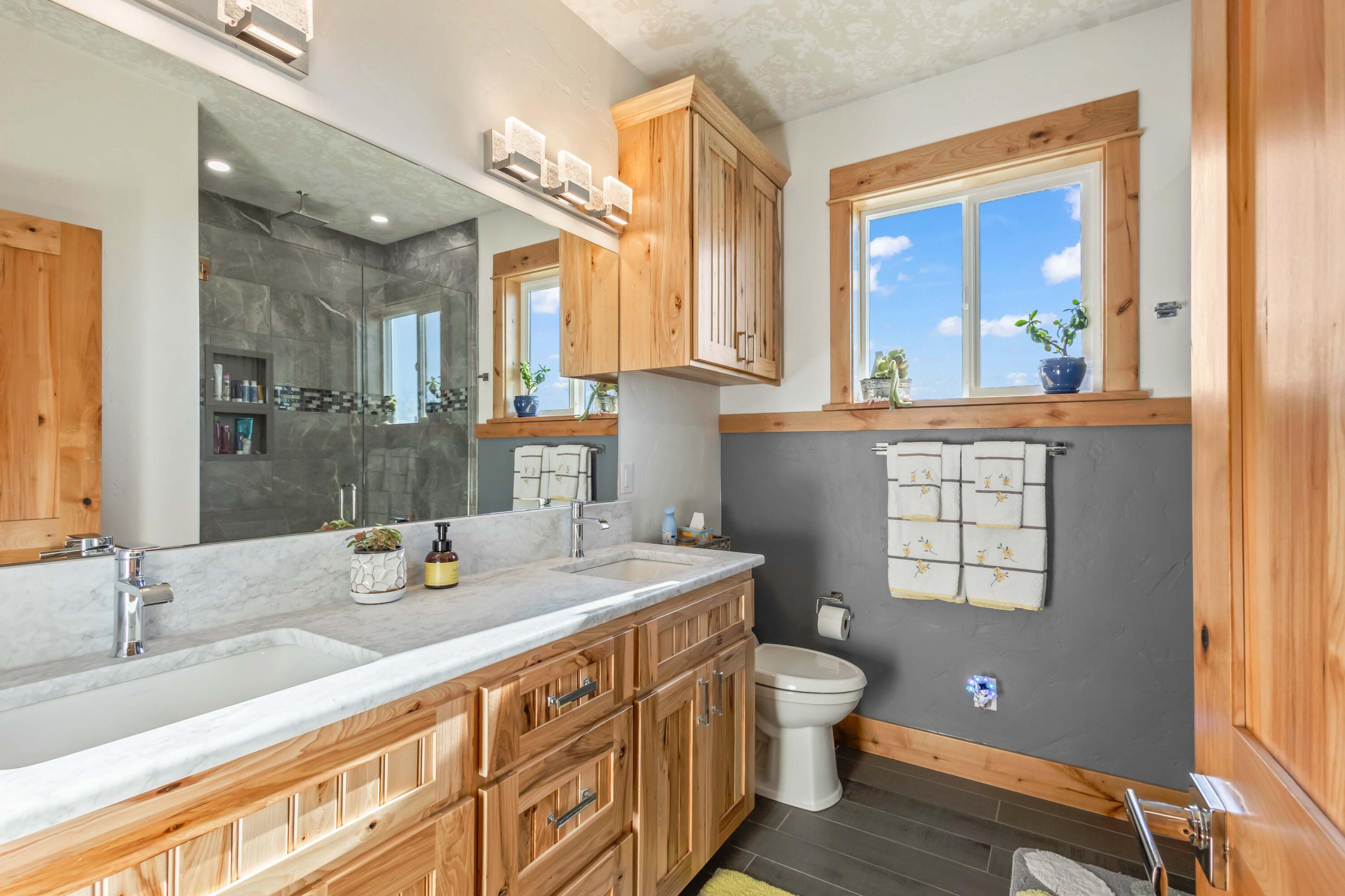 5582 North Mckay Road Prineville, OR 97754 - Photo 24 of 54 a bathroom with a granite countertop sink mirror and a toilet