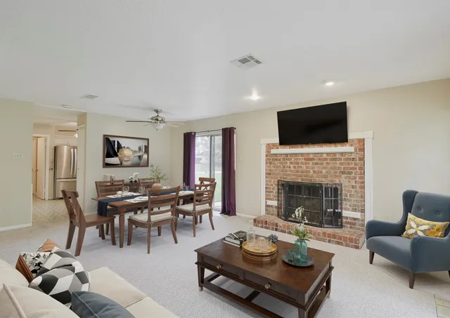 a living room with furniture fireplace and a flat screen tv