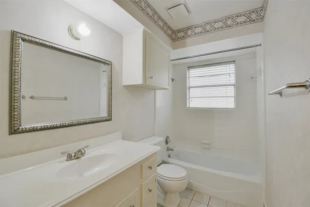 a view of a swimming pool with a table and chairs under an umbrella
