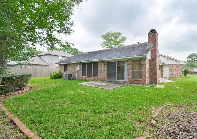 a view of a house with a yard and swimming pool