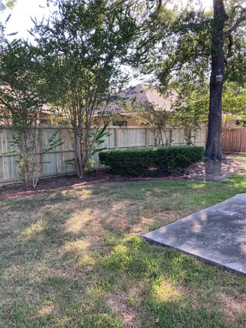 a view of a house with backyard and a patio