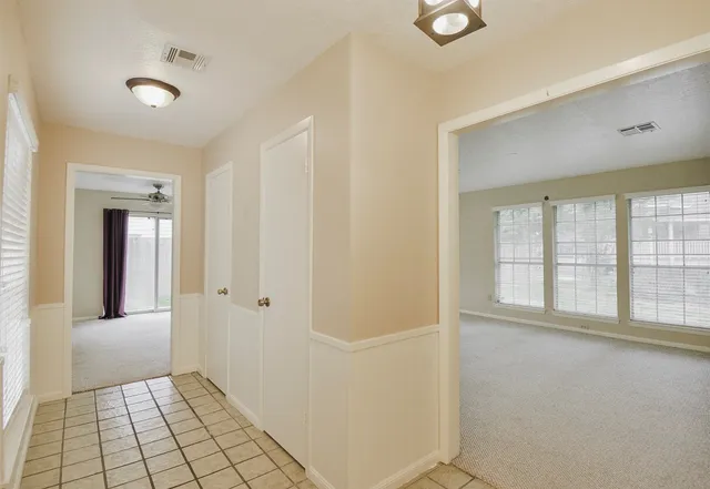 a view of an empty room with a fireplace and a window