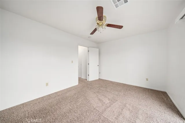 a view of a room with a hanging light and carpet