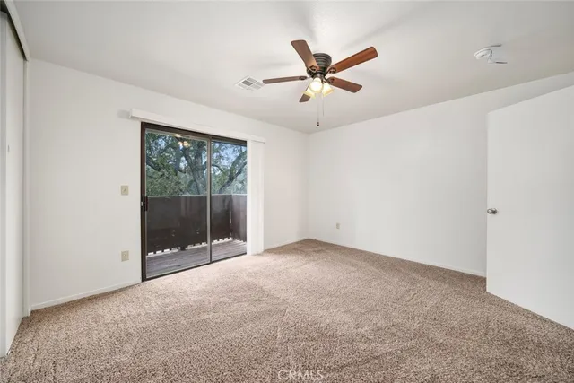 a view of a livingroom with a ceiling fan and window
