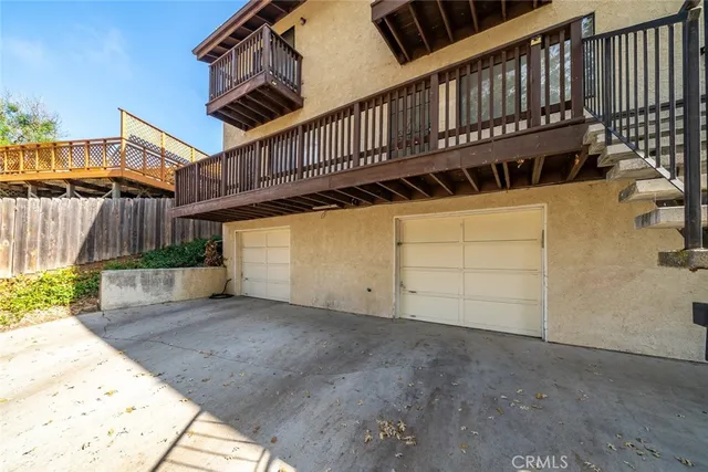 a view of a house with wooden deck